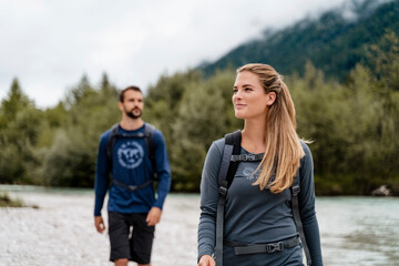 Young couple on a hiking trip at riverside, Vorderriss, Bavaria, Germany