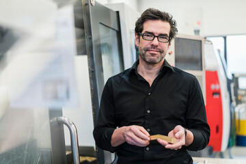 Portrait of a confident businessman in a factory