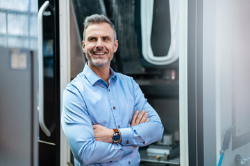 Portrait of a confident businessman in a factory