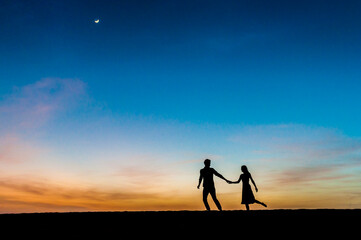 Couple at sunset in the dunes, Gran Canaria, Spain