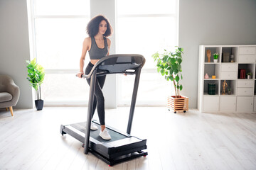 Photo of nice adorable active girl going running physical exercises in gym daylight interior indoors