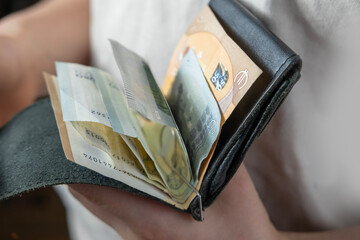 child holding wallet, takes out euro, theft money, managing pocket money, encouraging good financial behavior, economic awareness, money management