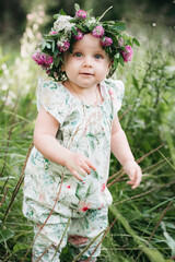 Portait of cute little girl with flower wreath on her head