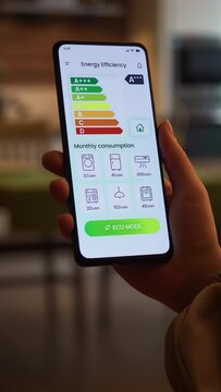 Turning on ECO mode on smart home app. Increasing savings by decreasing energy consumption of a house. Fictional Interface, vertical video.