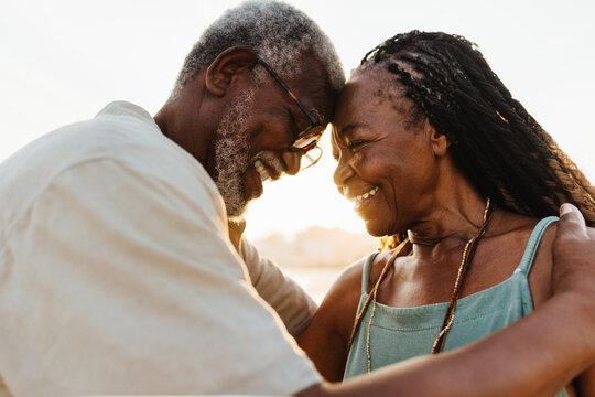 Happy elderly couple enjoying a moment of love on the beach.