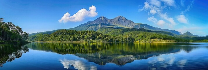 Obraz premium Mountain Panorama. Reflection of Volcanic Mountain in Calm Lake with Green Forest Surrounding