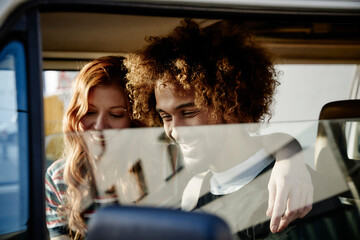 Happy young couple in a car