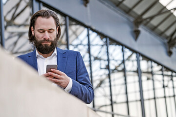 Businessman checking cell phone