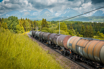 Transportation tank cars with oil during summer day. Railway containers. Freight railway wagons....