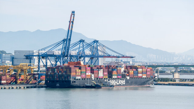 Busan, South Korea - 10.01.2023:
Ultra large container ship Hapag Lloyd has loading and discharging operations in container terminal of port New Busan in stead of living buildings of Busan city 