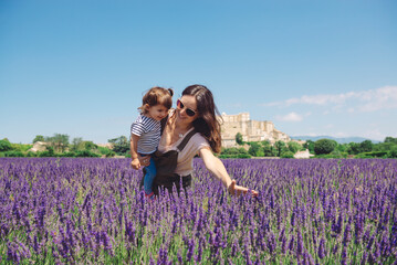 France, Grignan, mother and little daughter having fun together in lavender field