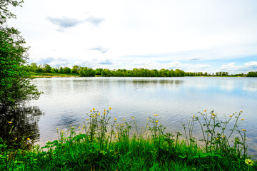View of the Menzelen leisure lake in Alpen on the Lower Rhine. Landscape by the lake with the surrounding nature.
