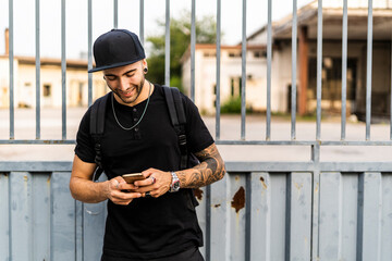 Young man using his smartphone in the city