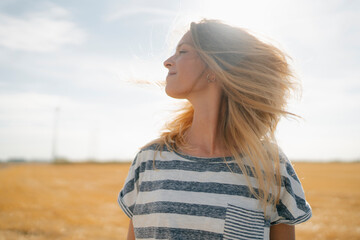 Portrait of smiling young woman in rural landscape