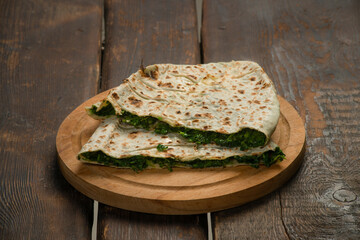 traditional pie with herbs and cheese on wooden board .jingyal