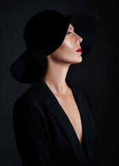 Elegance, hat and profile of woman in studio for fashion, style and designer clothing on black background. Glamour, dark and mysterious person with cosmetics for luxury, thinking and wealth or art