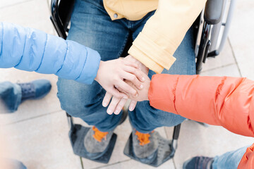 Close-up of father with son stacking hands in park