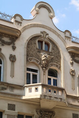 The balcony on the facade of the elaborate Aron Levi Trading house, surrounded by ornaments and reliefs, an example of Art Nouveau architecture in the city center of Belgrade, Serbia