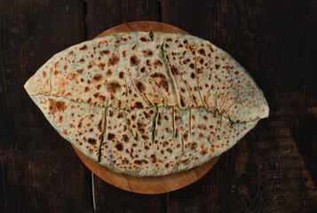 traditional pie with herbs and cheese on wooden board .jingyal