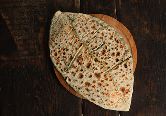 traditional pie with herbs and cheese on wooden board .jingyal