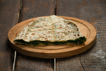 traditional pie with herbs and cheese on wooden board .jingyal