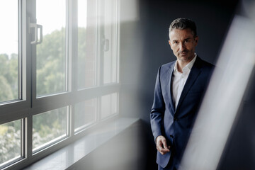 Portrait of confident businessman at the window