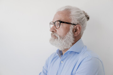 Portrait of serious mature man with beard and glasses