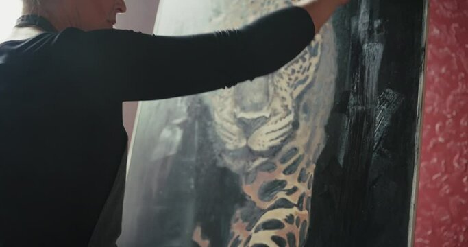 Artist Painting Leopard on Canvas