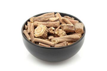 Close-up of Dry Organic Vridha Daru (Argyreia speciosa) barks, in black ceramic bowl. Isolated on a white background.