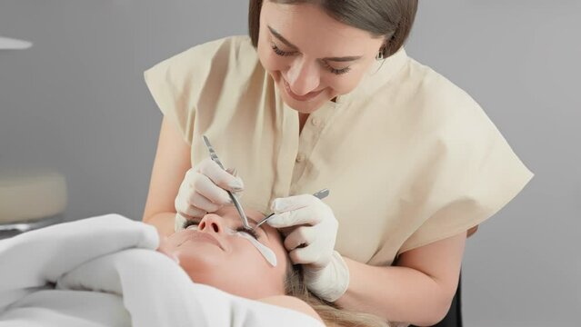 Experience professional eyelash extensions at a beauty salon, with skilled technicians ensuring your comfort and satisfaction. Closeup shots reveal meticulous care during the procedure