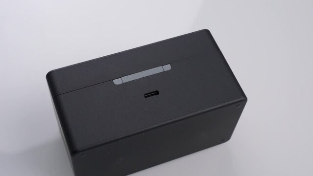 A black USBC rectangular device is placed on a white surface with a MicrostockPlus watermark