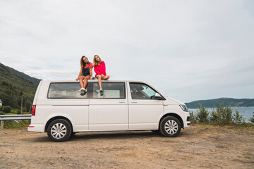 Friends traveling through Norwegian lapland with a camping van