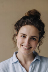 Portrait of smiling young woman with bun