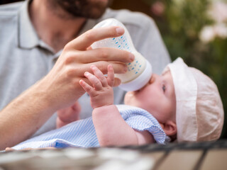 Father bottle-feeding baby girl