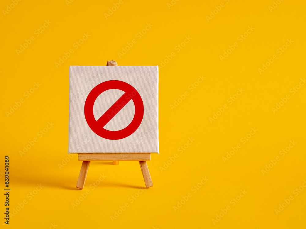 Wall mural a canvas with no entry sign on an easel with yellow background with copy space.