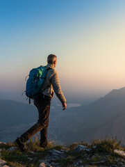 Rear view of hiker on mountaintop, Orobie Alps, Lecco, Italy