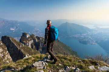 Rear view of hiker on mountaintop, Orobie Alps, Lecco, Italy