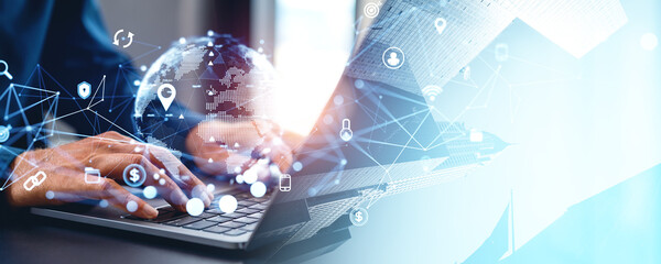 Businessman hands typing on laptop, earth globe and internet of things icons