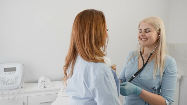In a healthcare setting, a healthcare provider listens to a female patients heart and lungs using a stethoscope, ensuring highquality care and an accurate diagnosis for her medical needs