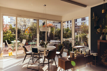 Dining room area with sun shining in from terrace in spring