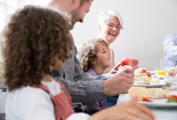 Happy extended family having lunch at home