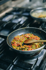 Close-up of a dish in pan in restaurant kitchen