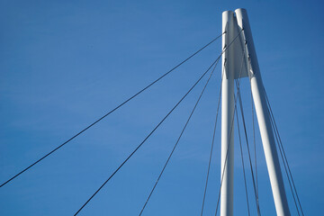 Fototapeta premium Cable-stayed bridge and cloudless sky - view from below