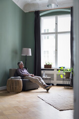 Relaxed mature man sitting at home