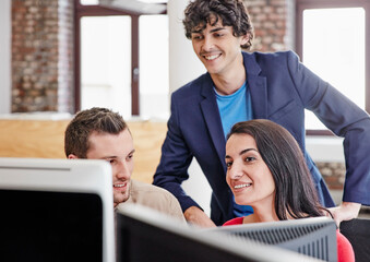 Creative team working together , using computer