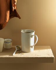 a decanter on the table with warm ragged tea