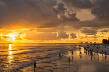 USA, Florida, Fort Myers, silhouettes of Fort Myers Beach and tourists with a huge rain cloud above during sunset