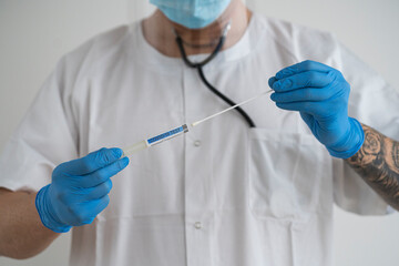 Man in protective wear taking a covid-19 swab