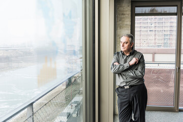 Senior businessman looking out of window