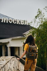 A young girl stands on a stone old bridge and enjoys the views of nature and buildings. Hotel...